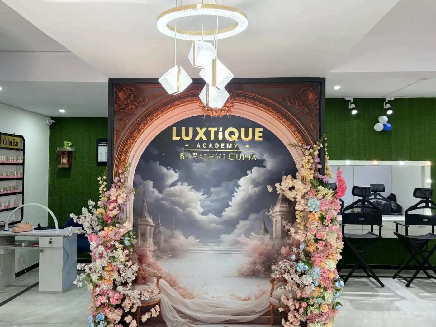Director Rashmi Gupta — warm portrait at the Luxtique Academy brand backdrop