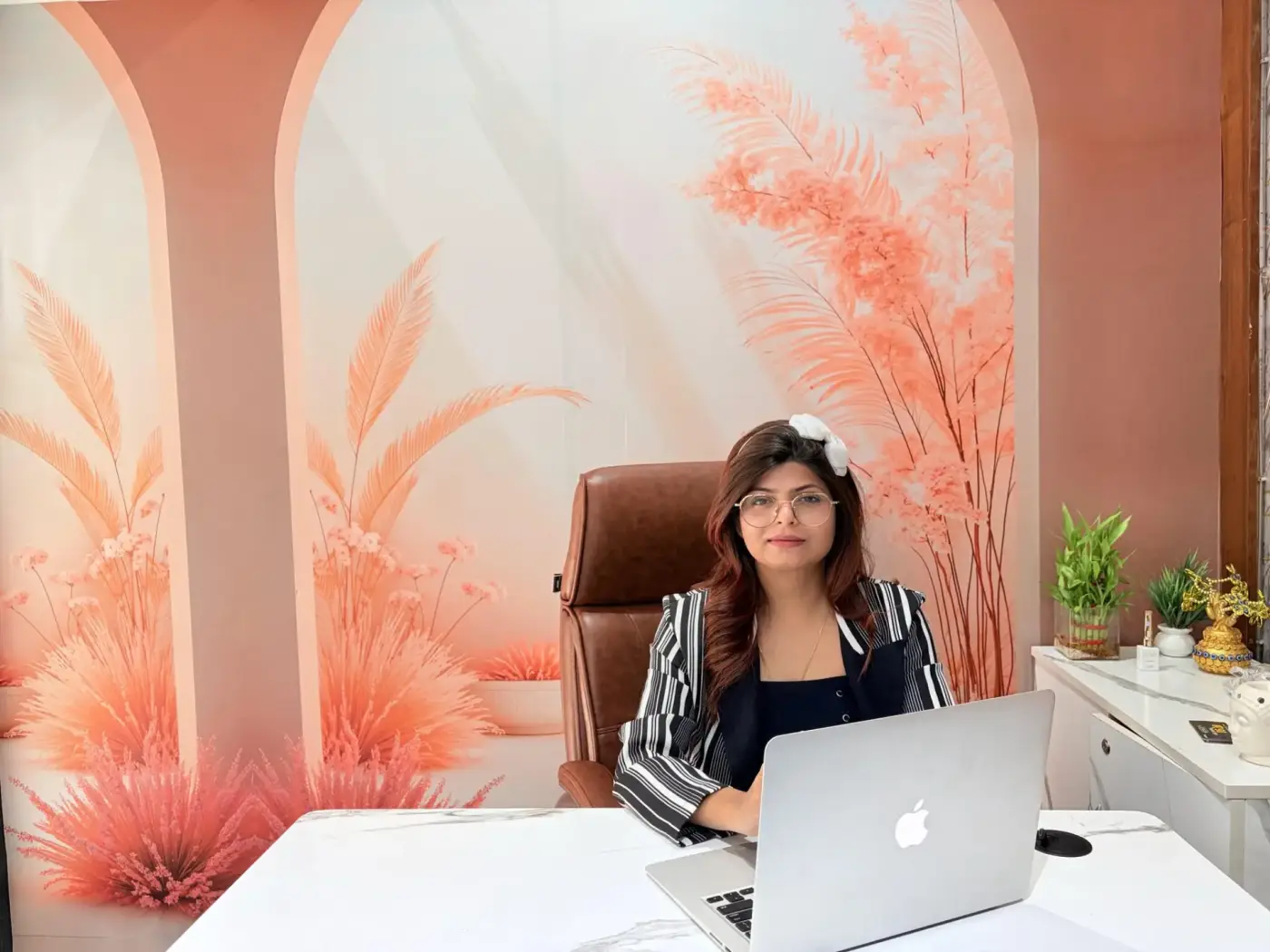 Rashmi Gupta seated at her director desk inside the Luxtique Academy studio