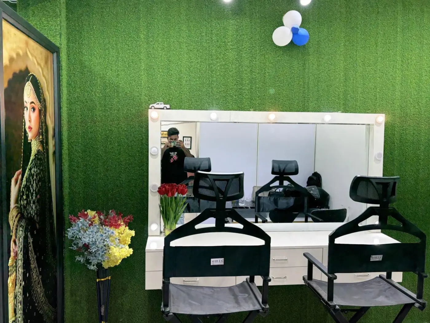 Twin makeup vanities with director chairs and floral styling