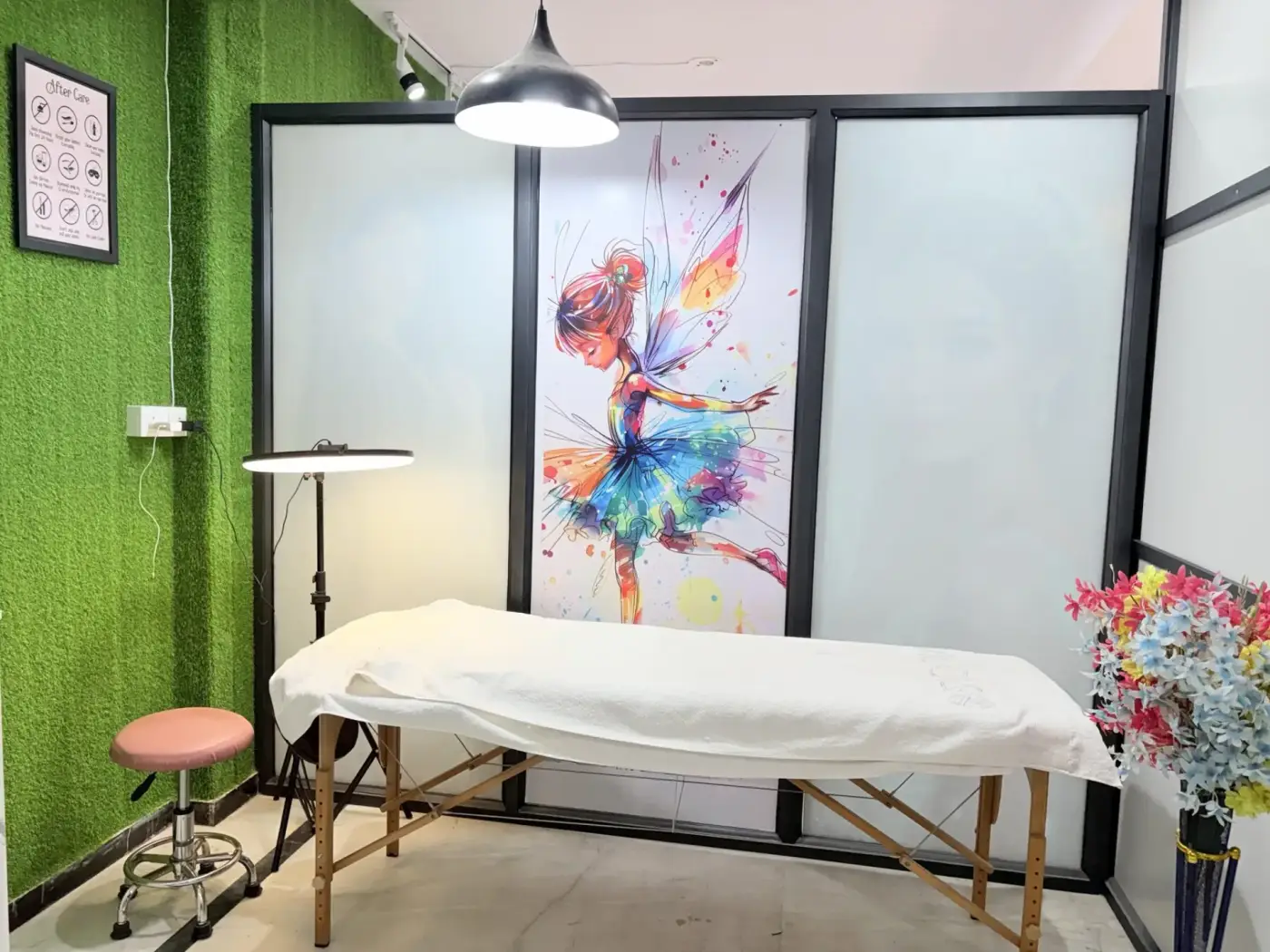 Lash and brow treatment room with linen-draped bed